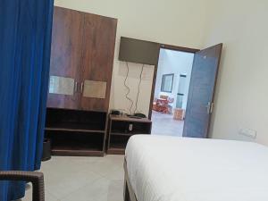 Postel nebo postele na pokoji v ubytování Coorg Vismaya Resort