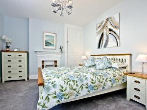 a bedroom with a bed and a chandelier at Cornerstone in Castletown