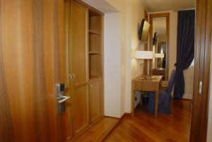 a door to a room with a desk and a bed at Hotel Iris in Genoa