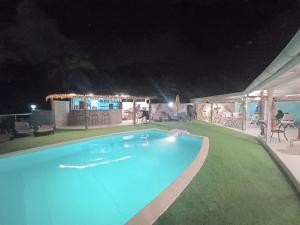 a swimming pool at night with blue lights at La Rose du Bresil Marie-Galante in Capesterre-de-Marie-Galante