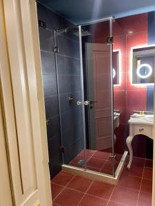 a shower with a glass door in a bathroom at Hotel Hymeti's Palace in Pogradec