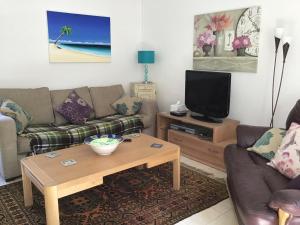 a living room with a couch and a coffee table at The Coach House in Falkenham