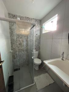 a bathroom with a shower and a toilet and a sink at Apartamento 2 Bairro Boa Vista 1 in Caruaru