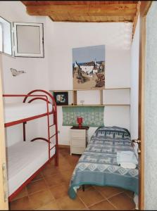 a bedroom with two bunk beds in a room at Il Nido di Mortelle II in Messina