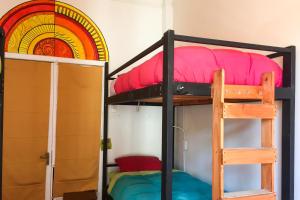 a bunk bed in a room with a rainbow at Hostal Po in Valparaíso