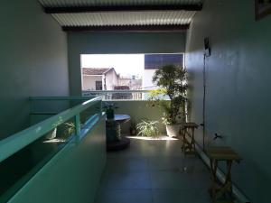 a room with a balcony with a window at Apartamento 2 - CARUARU-PE in Caruaru