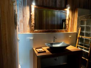 a bathroom with a sink and a mirror at Little Lodge in Gili Trawangan