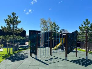 a playground with a slide in a park at PUŠIS IR JŪRA - Mano Jūra 2 complex - Kunigiškiai in Palanga