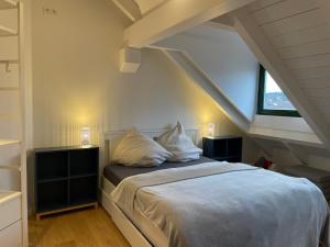 a bedroom with a bed with two pillows on it at Gemütliches Loft in Geretsried