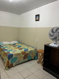 a bedroom with a bed and a fan and a television at Apartamento 3 Bairro Boa Vista 1 Caruaru-PE in Caruaru