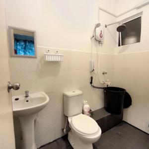a small bathroom with a toilet and a sink at Comfy UUC Homestay Bajet Kota Kinabalu in Kota Kinabalu