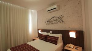 Postel nebo postele na pokoji v ubytování Pampulha Lieu Hotel + 31 fotografií