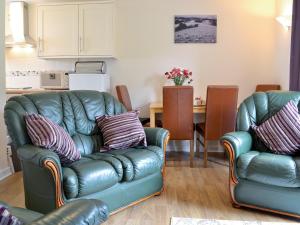 a living room with a couch and a table at Owl Cottage in Llandeilo