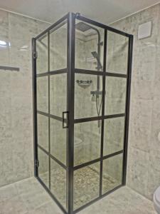 a shower with a glass door in a bathroom at Villa Fantastica Apartments in Mysłakowice +28 photos