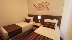 Letto o letti in una camera di Pampulha Lieu Hotel