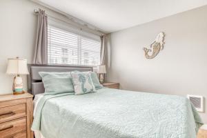 a bedroom with a bed and a window at Whale Watcher Condo #3 in Rockaway Beach