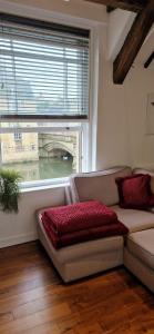 a living room with a couch and a large window at Riverside Stamford Stays in Stamford