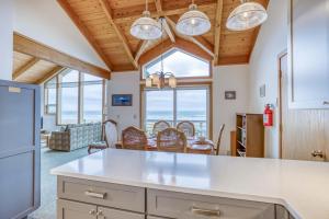 a kitchen and dining room with a view of the ocean at Sea Star #1 (MCA 51 A-GF) in Manzanita