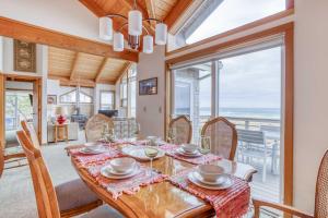 a dining room with a table and chairs with a view of the ocean at Sea Star #1 (MCA 51 A-GF) in Manzanita