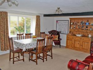 a dining room with a table and chairs at Elm Cottage in Beckermonds