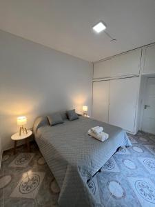 a bedroom with a bed with two lamps on it at ljapartments Andrade 3 in Villa Marini