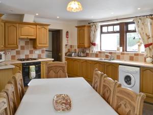 a kitchen with a table and chairs in it at The Stables - 24971 in Frosterley