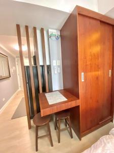 a room with a wooden desk and a closet at Amirah’s Place Azure North in San Fernando