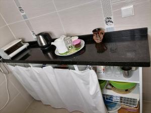a kitchen counter with a towel hanging from a shelf at TANGER beach in Tangier