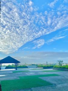a pavilion with a blue sky and clouds at Amirah’s Place Azure North in San Fernando