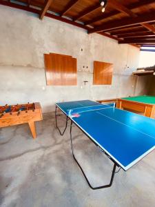 una mesa de ping pong en una habitación con una pelota de ping pong en Rest house, en Laguna