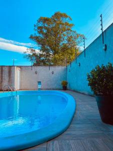 a large blue swimming pool on a patio at Rest house in Laguna +17 photos
