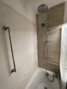 a bathroom with a shower and a bath tub at Cap Estérel Rivièra Studio in Saint-Raphaël