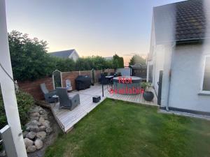 a backyard with a deck with a table and chairs at VV Apartments 50 in Ringsted