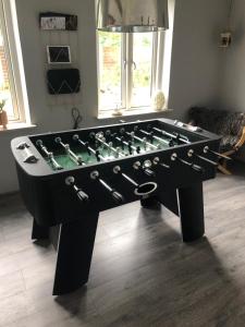 a large black foosball table in a living room at VV Apartments 50 in Ringsted