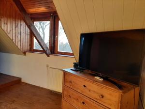 a flat screen tv sitting on a dresser in a room at Ház a kishegyen in Felsőörs