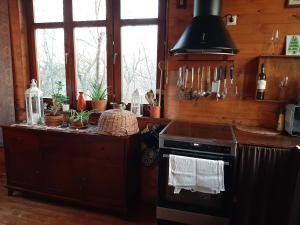 a kitchen with a stove and a counter with towels at Ház a kishegyen in Felsőörs