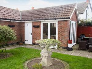 a brick house with a fire hydrant in the yard at Twenty in Sutton on Sea