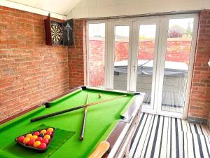 a room with a pool table with balls and bats at Twenty in Sutton on Sea
