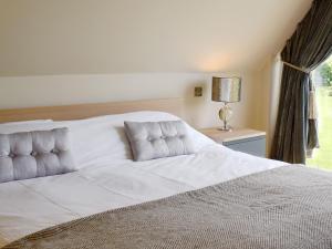 Schlafzimmer mit einem großen weißen Bett und einem Fenster in der Unterkunft The Glass Room in Dedham