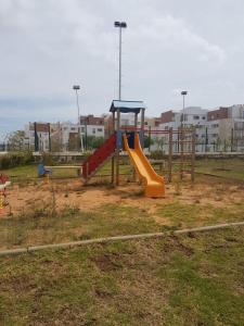 a playground with a slide in a park at TANGER beach in Tangier