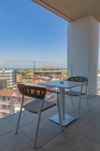 a table and chairs on a balcony with a view at THE ONE CAORLE - Hotel & Apartments ****s in Caorle