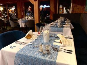 a long table with glasses and napkins on it at Hôtel Le Labrador 1971 in Les Gets +176 photos