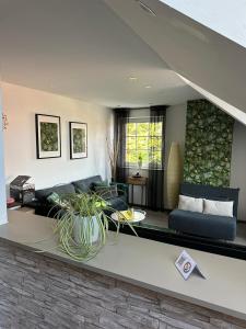 a living room with a couch and a table at Apartment nahe Naturschutzgebiet „Wurmtal“ in Würselen