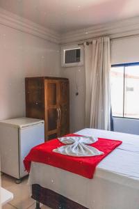a room with a bed with a red blanket on it at Diamantina Palace Hotel in Morro do Chapéu