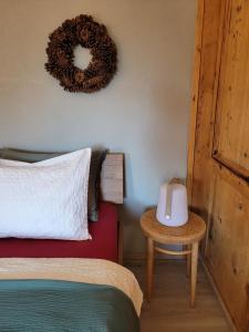 a bedroom with a bed and a wreath on the wall at Ferienwohnung PARDI in Lenz