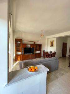Sunny House في روما: غرفة معيشة مع أريكة وطاولة مع برتقال