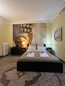 a bedroom with a large bed with two towels on it at Domus La Foce Hotel Self check in in Genoa