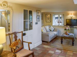 a living room with a couch and a chair at Swallows Nest in Saint Lawrence