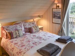 a bedroom with a bed with pillows on it at Swallows Nest in Saint Lawrence