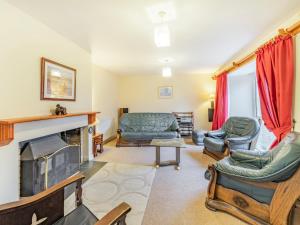 sala de estar con muebles y chimenea en Galena en Glenridding